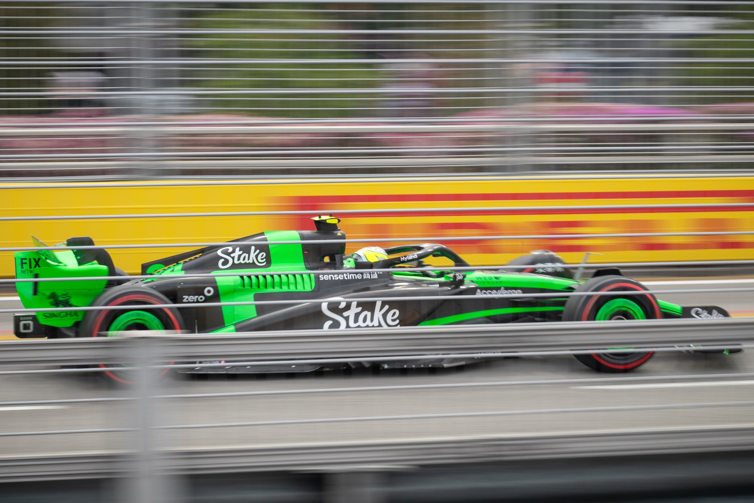 Formula 1 car at full speed under the floodlights of Marina Bay Street Circuit